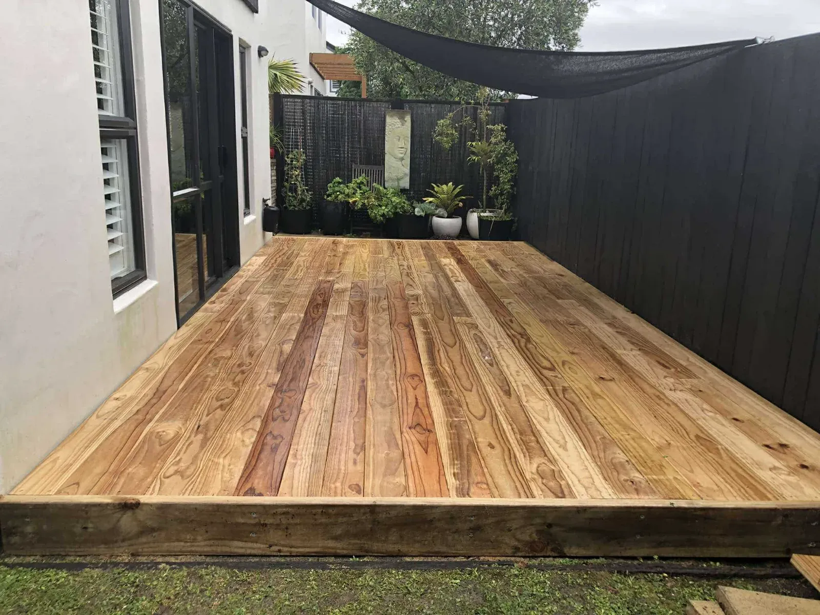 Pine courtyard deck beside a townhouse, Auckland