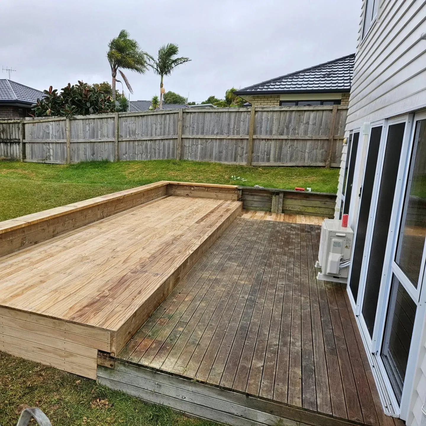 Raised pine deck platform on a sloping lawn, Auckland