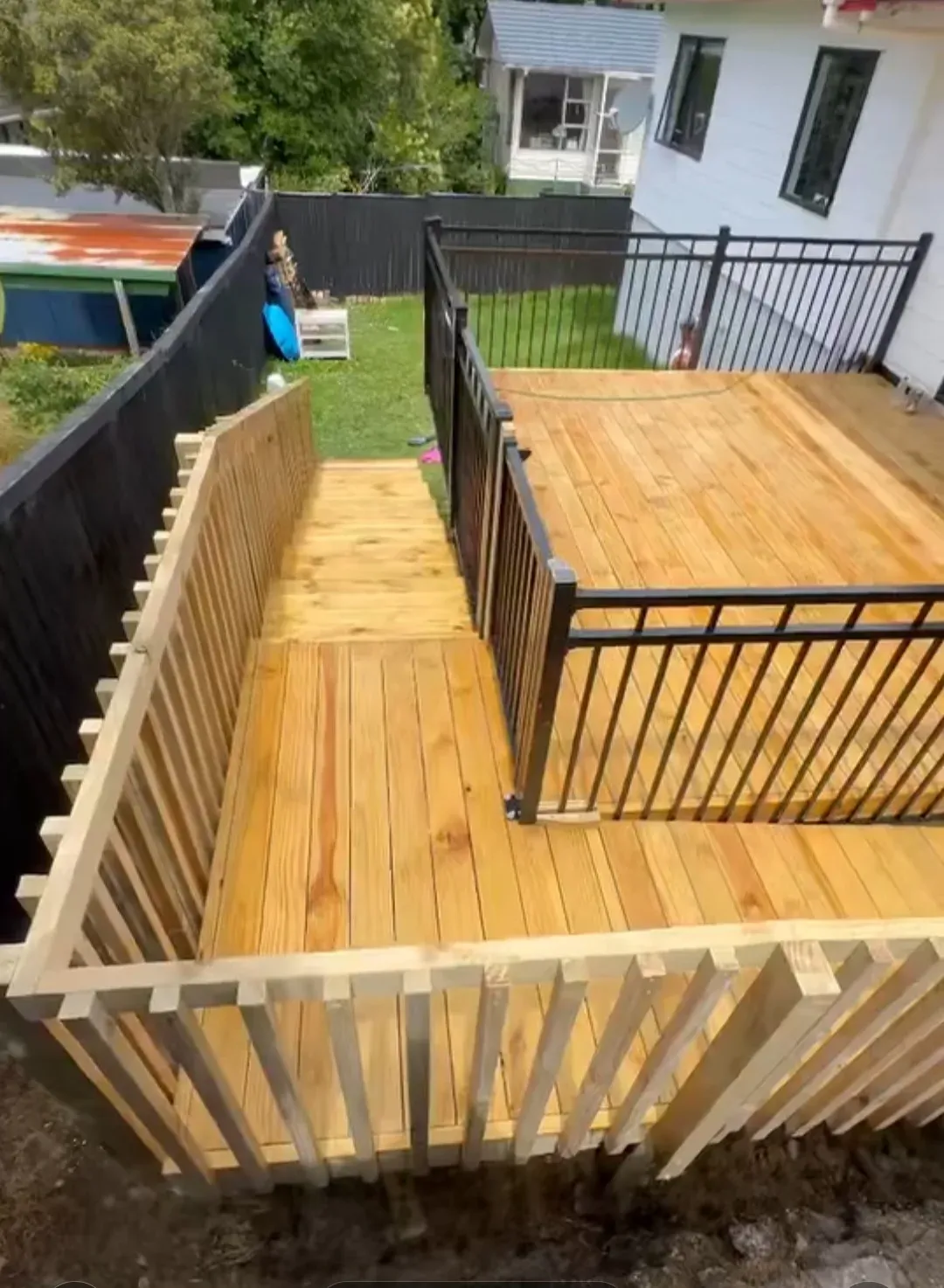 Pine deck with stairs and black balustrade, Auckland
